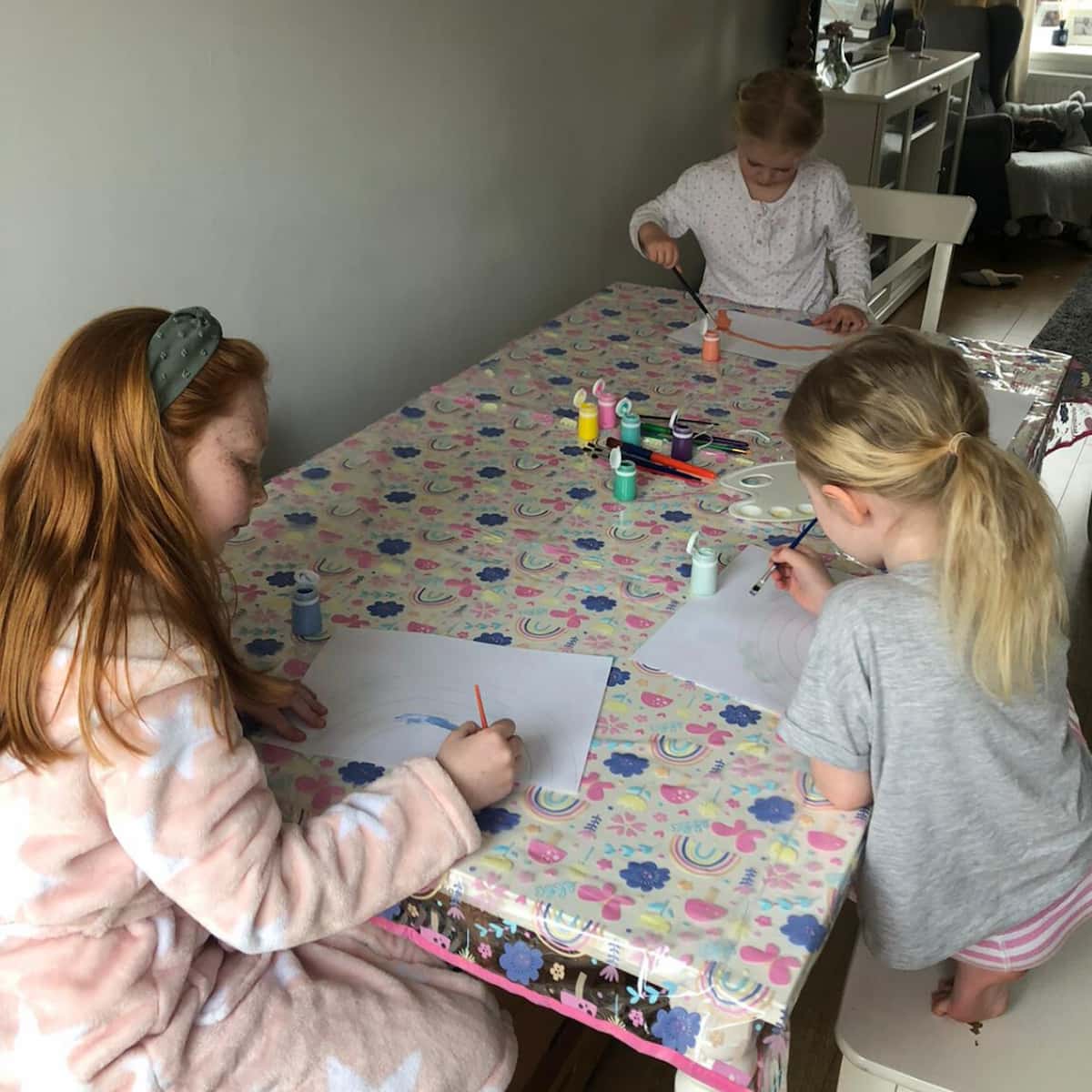Photo of three girls drawing at a table