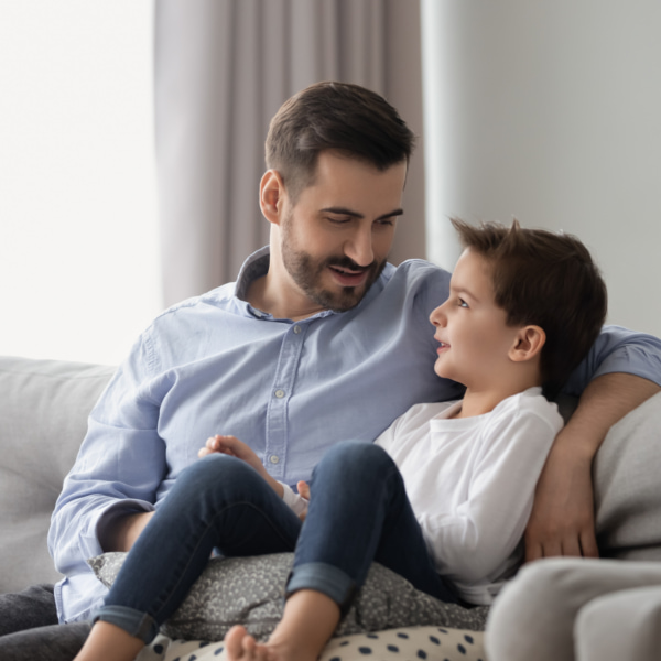 Photo of dad and son on couch