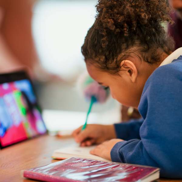 Photo of a little girl writing 