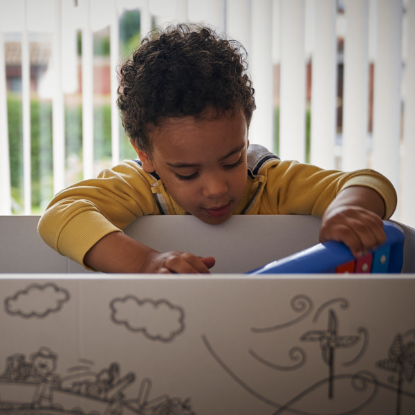 Photo of a toddler getting toys out of the baby box