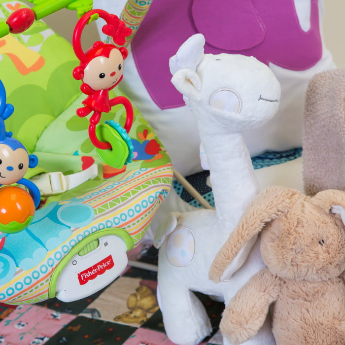 Image of brightly coloured children's toys sitting on the floor.