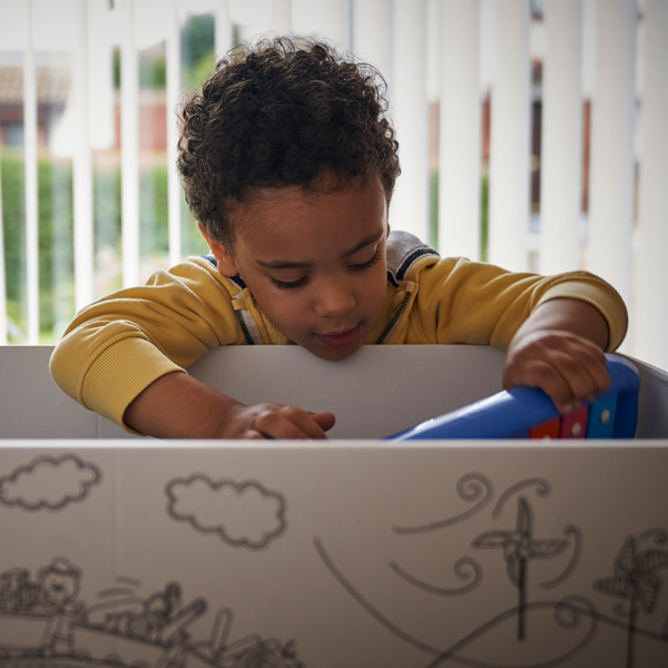 photo of toddler putting toy in box