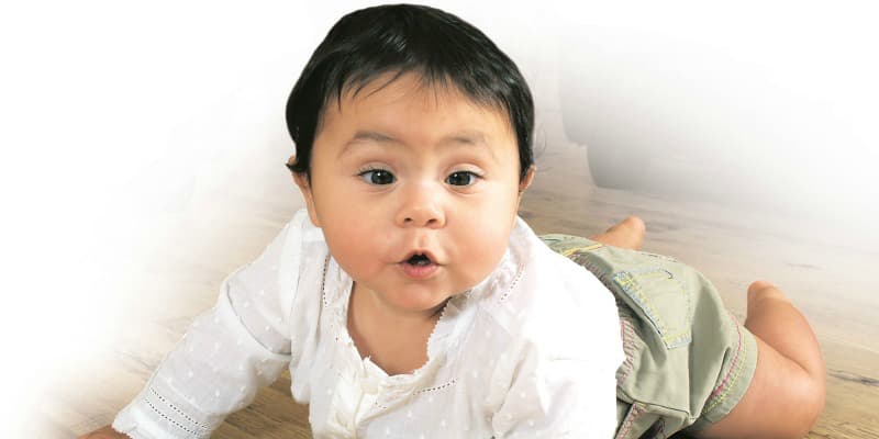 Photo of a toddler crawling on the floor 