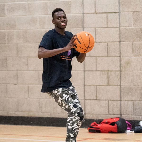 Teen playing basketball