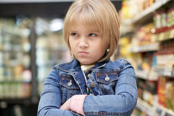 child pouting in shop
