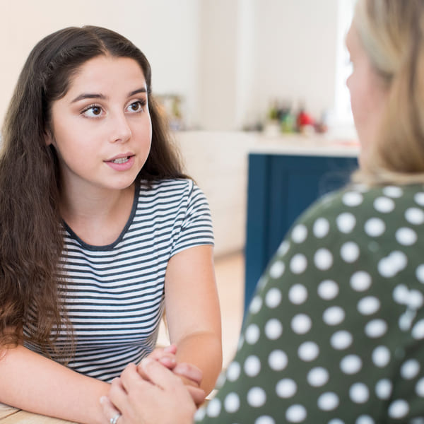 A mother conversing with her teenage daughter