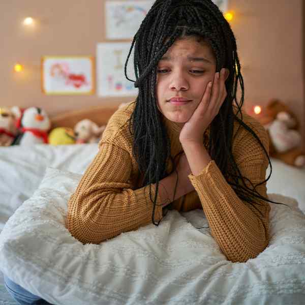 girl-looking-sad-in-bedroom-button