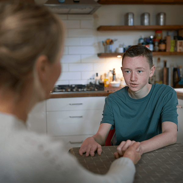 mother-son-talking-calmly-in-kitchen-button