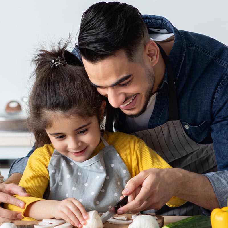 Dad and daughter cooking together