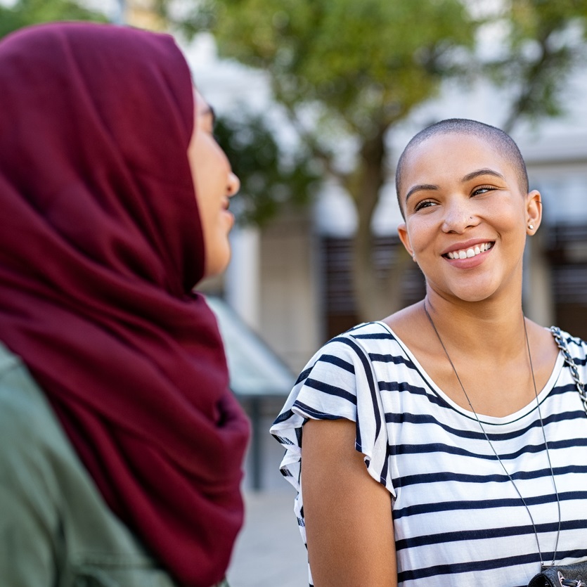 Muslim woman talking to a friend outside