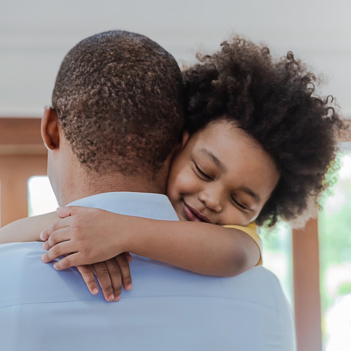 Father hugging child