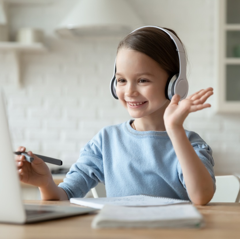 Little girl wearing headphones learning Gaelic
