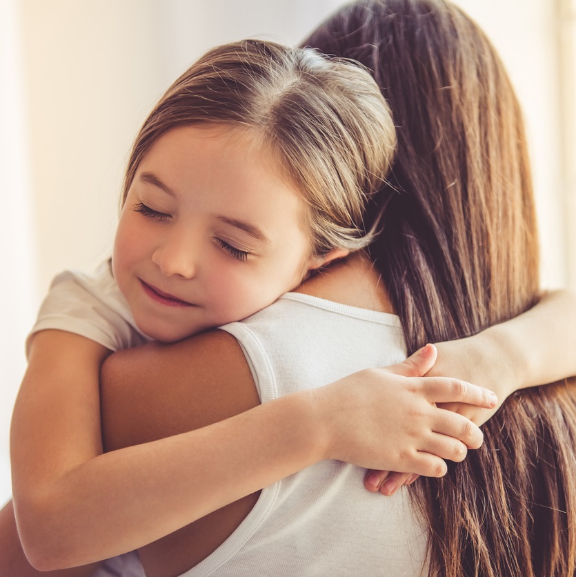Mother and daughter hugging